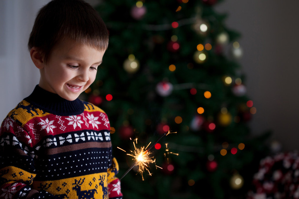 Beautiful Little child holding burning sparkler on New Year's Ev - Fotografie, Obrázek