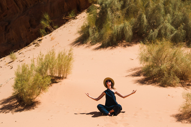Calm peaceful concept. Girl relaxing meditation in Wadi Rum desert, Jordan. Travel lifestyle, summer vacations, retreat. - Photo, Image