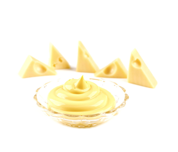 Cheese sauce in a bowl, cheese triangles  blurred background iso - 写真・画像