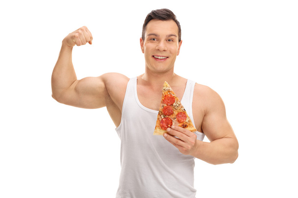 Man holding a slice of pizza and flexing his bicep - Foto, Imagem