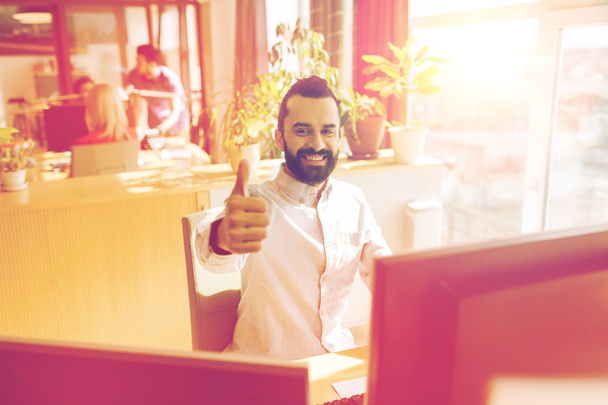 happy male office worker showing thumbs up - 写真・画像