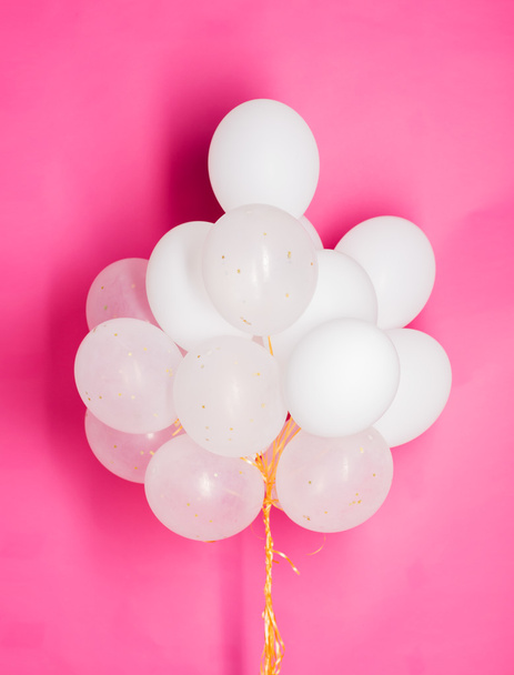 close up of white helium balloons over pink - Foto, Bild