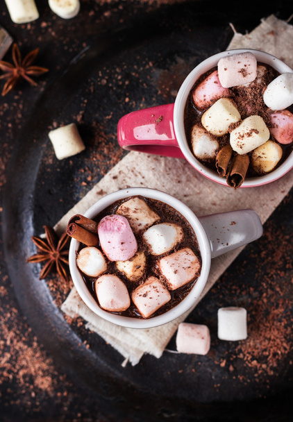 Hot chocolate with marshmallows and spices on grunge dark table - Photo, Image