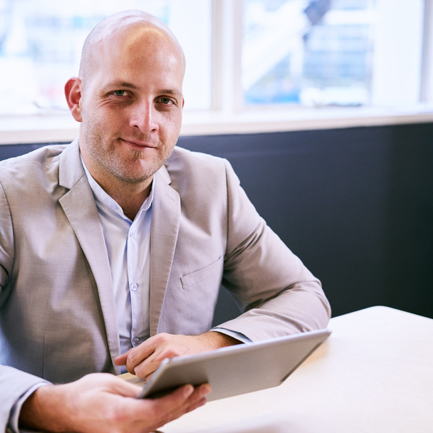 Happy business man holding tablet while looking at camera - Photo, Image