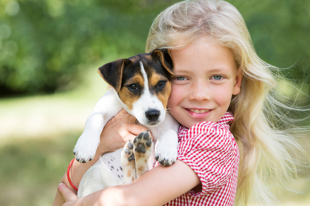 Portrait Of Girl Holding Pet Dog - Фото, зображення