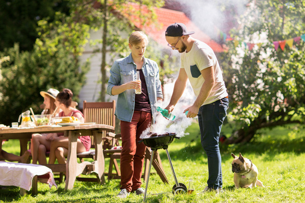 friends making barbecue grill at summer party - Zdjęcie, obraz