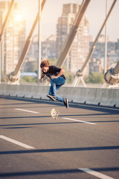 Skater doing tricks and jumping on the street highway bridge. Fr - Fotó, kép