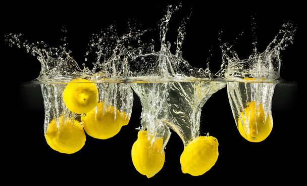 Group of fresh fruits falling in water on black - Foto, immagini