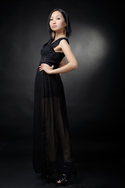 Asian woman in black dress - Фото, изображение