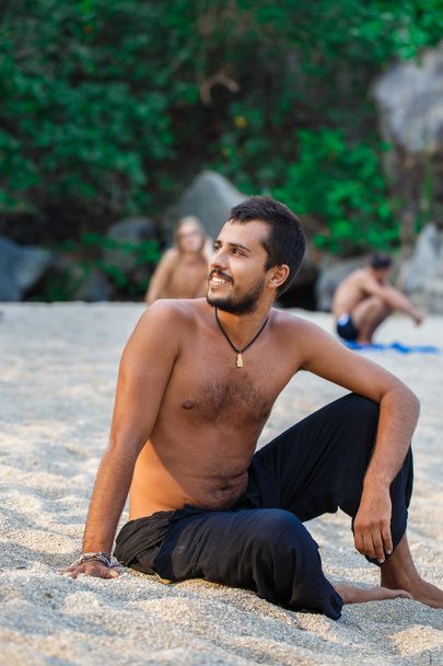 Man sitting on a beach - Photo, Image