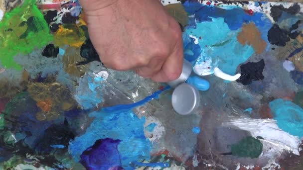 Painter squeezing paint out of tube - Footage, Video