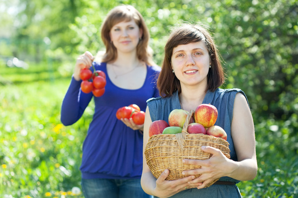 Girls with harvest in garden - Zdjęcie, obraz