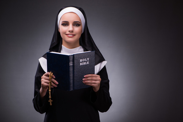 Religious nun in religion concept against dark background - Foto, immagini
