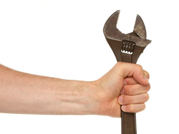 Old rusted adjustable wrench in a hand - Fotó, kép