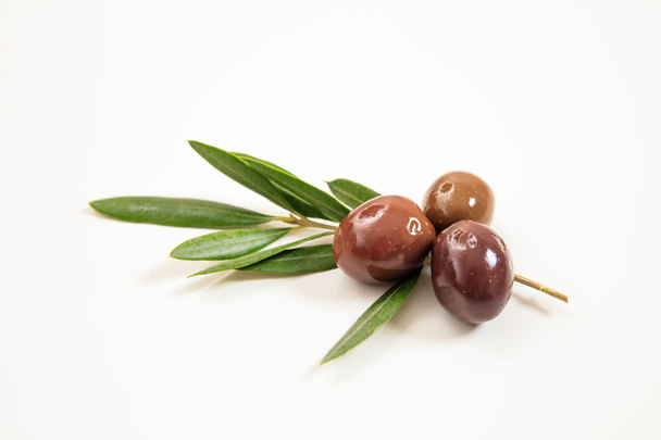 Olives and olive branch on white background - 写真・画像