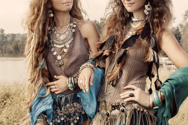 Two beautiful boho girls in ethnic jewelry. Close up - Zdjęcie, obraz