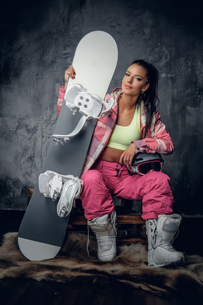 Female in a pink snowboarder costume - Photo, Image