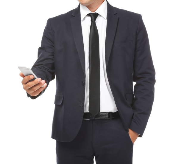 Businessman holding phone in hand on white background - Фото, изображение