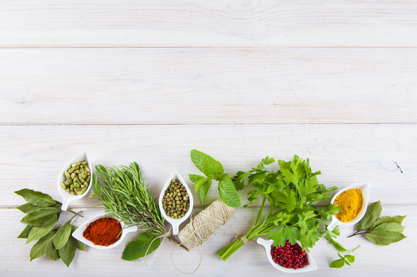 Fresh herbs and spices on a white wooden background - Photo, Image