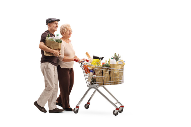 Mature couple pushing a shopping cart - Photo, Image