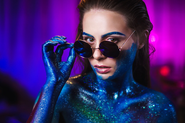 Portrait of beautiful woman painted with cosmic colors and spangled. - Foto, immagini