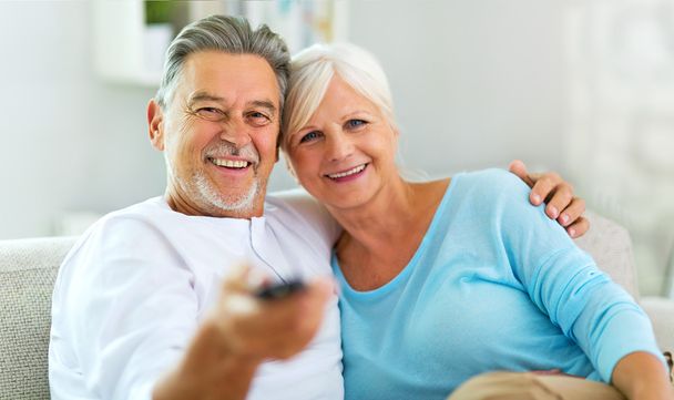 Senior couple with remote control - Photo, Image