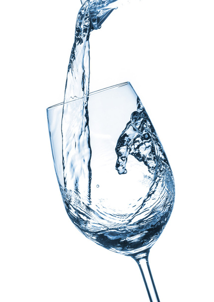 pouring water on a glass on white background - Fotó, kép