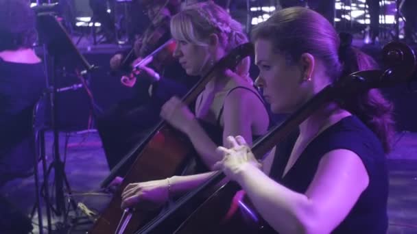 Rock Symphony Concert Ukrainian Tour Kiev Conductor Nikolai Lysenko Female Cellists on Foreground Musicians Are Playing Music Books on Stands Lights - Filmmaterial, Video