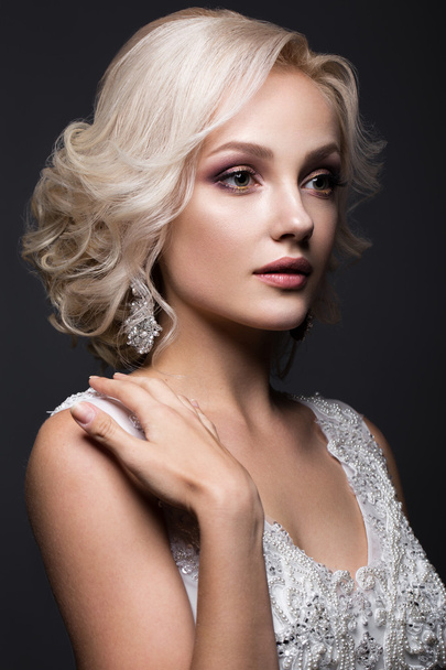 beautiful blond girl in image of the bride with wedding accessories on her head. Beauty face. - Fotó, kép