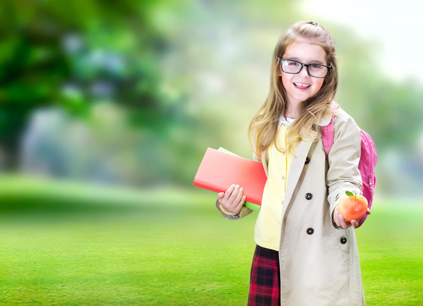 Child girl school age with apple education concept. - Fotó, kép