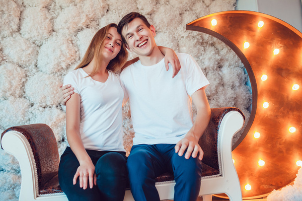 Young couple sitting embracing at home - Valokuva, kuva
