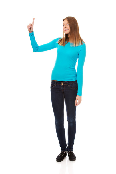 Young woman pointing up - Valokuva, kuva