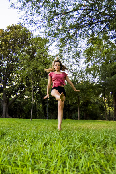Beautiful ballerina doing exercises for dancing outdoors - Фото, зображення