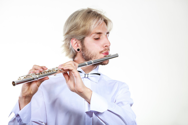 Male flutist playing his flute - Фото, зображення