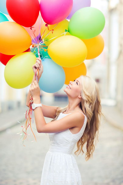 woman with colorful balloons - 写真・画像