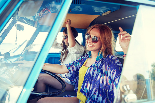 smiling young hippie women driving minivan car - Photo, image