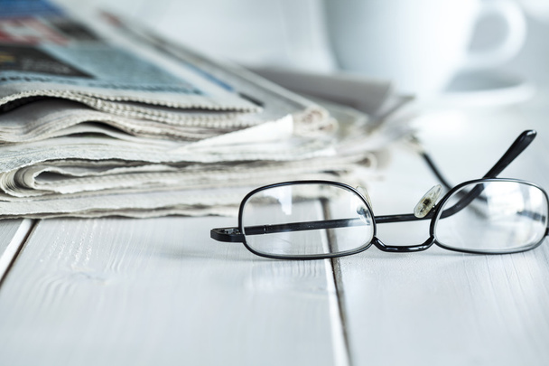 Stack of newspapers and eyeglasses - Φωτογραφία, εικόνα