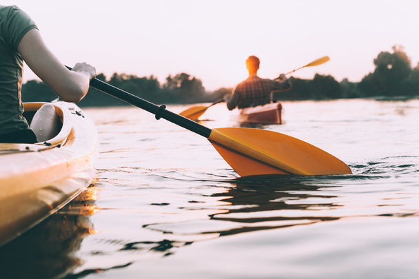beautiful couple kayaking on river together - Zdjęcie, obraz