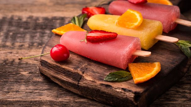refreshing fruit popsicle lollies on wooden table with berries and fruits - Photo, Image