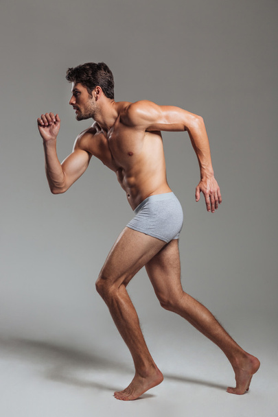 Portrait of a confident naked athletic man in underwear posing - Photo, image