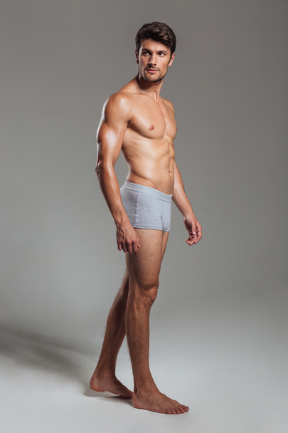 Portrait of a serious muscular man in underwear looking away - Fotoğraf, Görsel