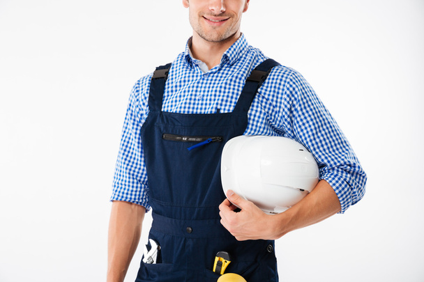 Cropped image of a worker holding helmet - Zdjęcie, obraz