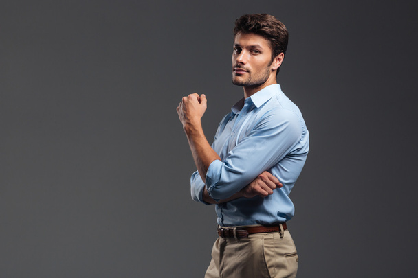 Side view of a successful handsome man with arms folded - Foto, imagen