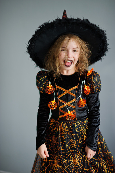 All Hallows Eve. Girl shows the evil sorceress. - Фото, изображение