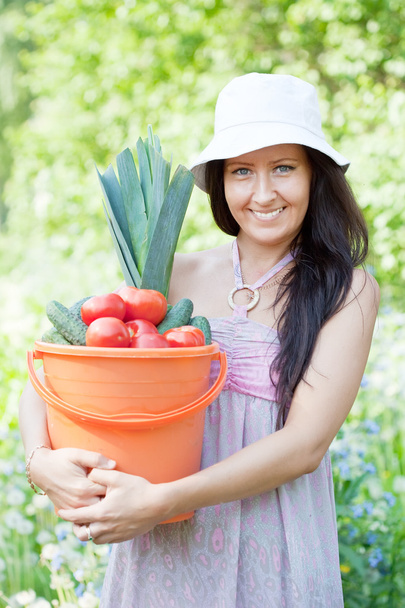 Happy woman holds vegetables harvest - Foto, afbeelding