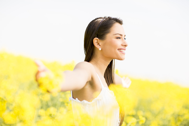 Young woman in the spring field - Photo, Image