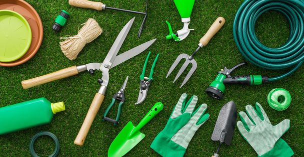 Gardening tools and utensils on a lush green meadow - Φωτογραφία, εικόνα