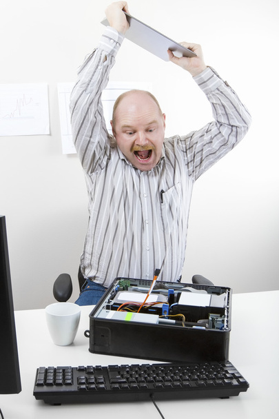 Businessman Banging File On Computer Chassis At Table - Photo, Image