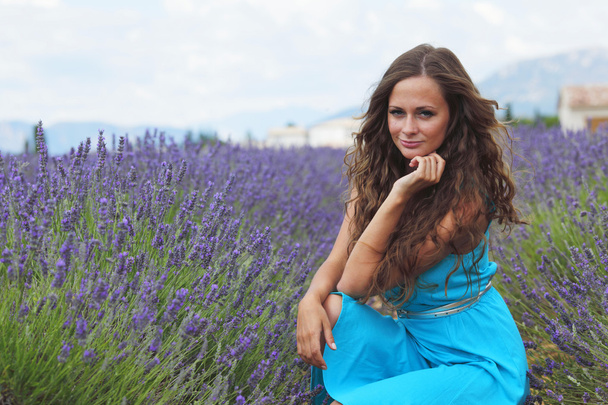 Woman sitting on a lavender field - Fotografie, Obrázek