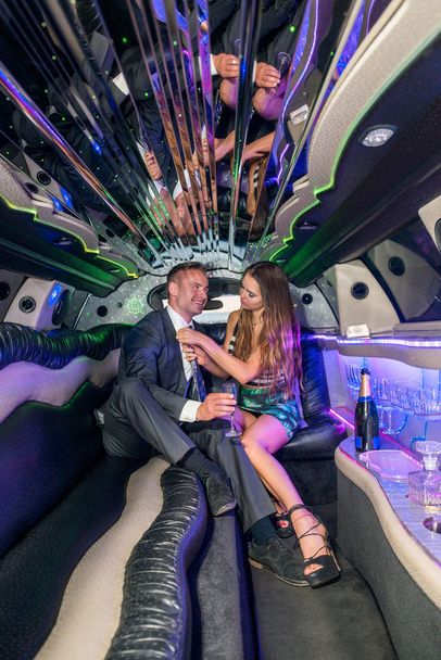 couple with champagne flute in limousine - Foto, Imagem